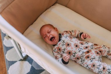 baby crying on a crib