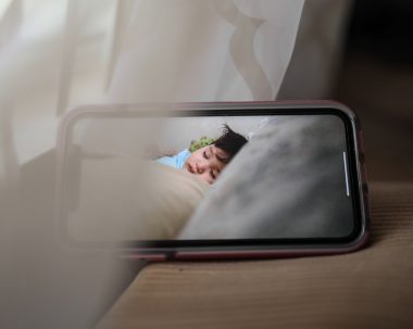 mobile phone with sleeping baby