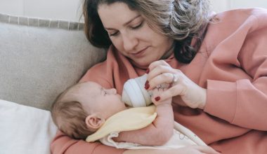 mother feeding bottle of milk to baby