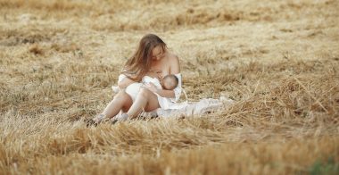 woman breastfeeding on a meadow