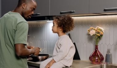 little girl and father talking in the kitchen
