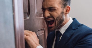 man shouting in front of a door