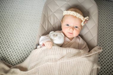 cute baby lying on a baby lounger