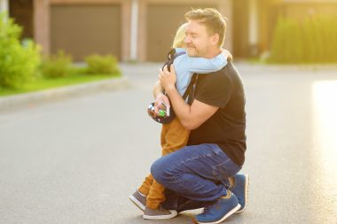 boy hugging father