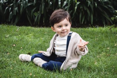 cute toddler sitting on grass