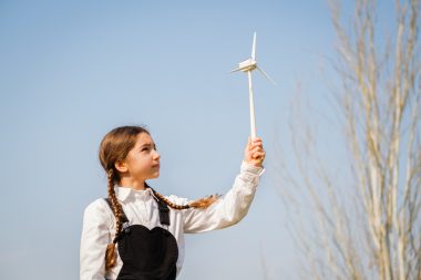 girl playing with a wind turbine