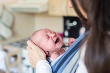 mom carrying crying baby