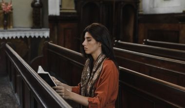 woman reading bible on a church