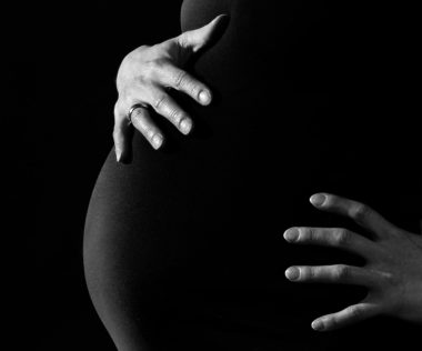 greyscale photo of a pregnant woman